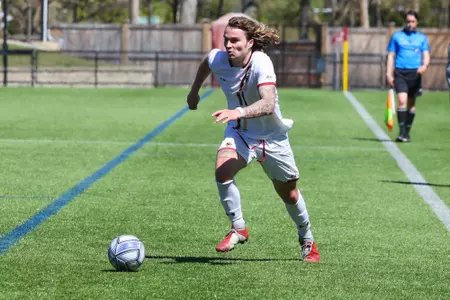 Michael Suski dribbles the ball up field against NC State.