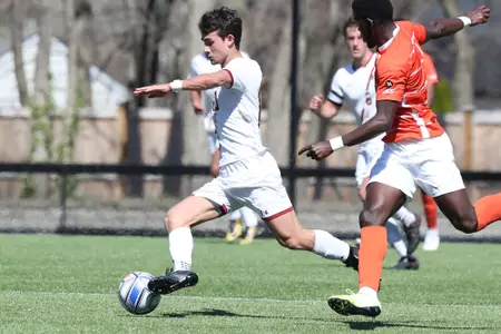 Amos-Shapiro Thompson dribbles the ball up field against Clemson.