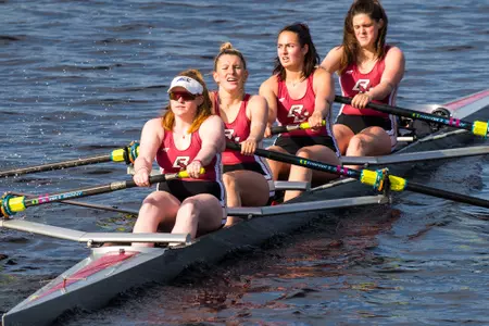 A BC four-person boat heads up the Charles River against BU.