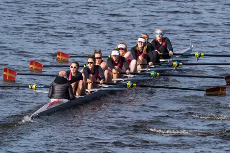 An Eagles eight-person boat competes on the Charles River against Holy Cross and UConn.