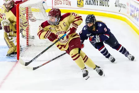 Cayla Barnes skates the puck behind the net against UConn.