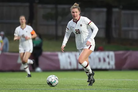 Alison Heckman looks to pass the ball up field against Northeastern.