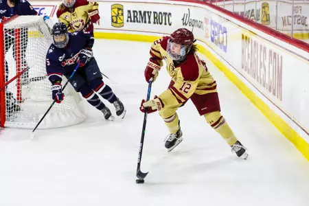 Olivia Finocchiaro carries the puck behind the net.