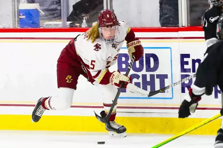 Savannah Norcross carries the puck up the ie.