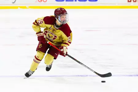 Hannah Bilka rushes the puck up the ice through the neutral zone.