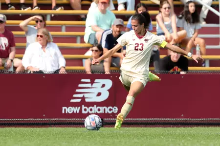 Michela Agresti kicks the ball against Holy Cross.