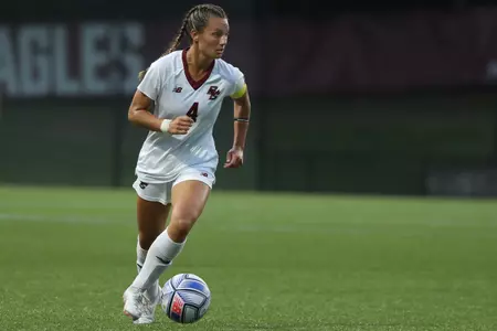 Jenna Bike takes the ball up the field against BU.