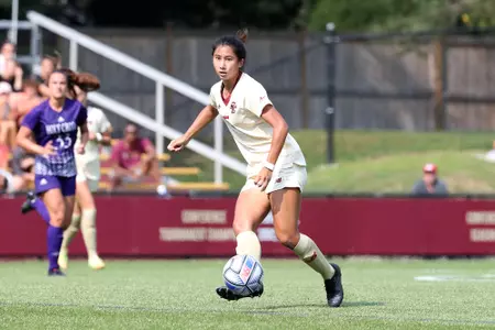 Sonia Walk kicks the ball up the field against Holy Cross.