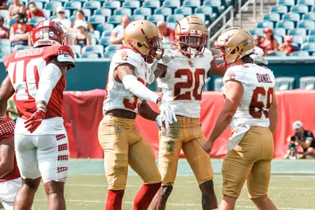 Elijah Jones is greeted after a tackle in the BC punt unit at Temple.