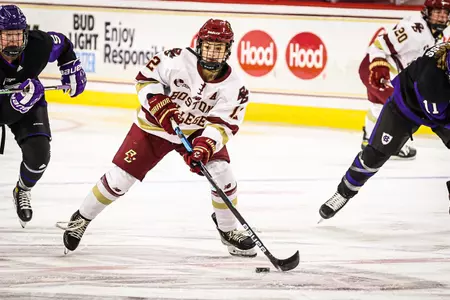 Olivia Finocchiaro carries the puck up the ice against Holy Cross.