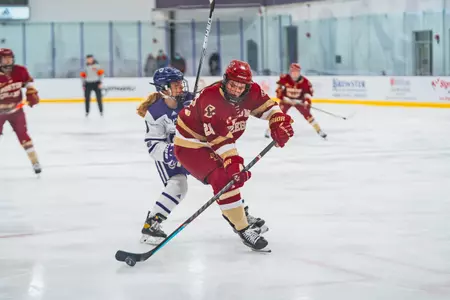 Abby Newhook battles for the puck against Holy Cross.