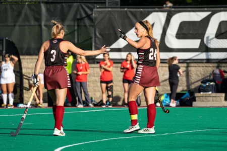 Sarah Johnson celebrating with Margo Carlin in field hockey game