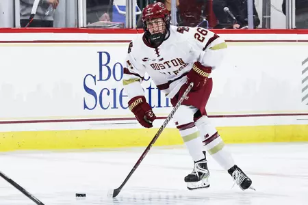 Sidney Fess skates the puck up the ice against Boston University.