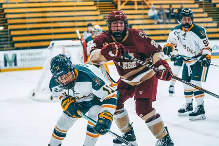 Jenna Carpenter fights for the puck against Vermont.