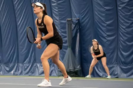 Hailey Wilcox and Sophia Edwards playing doubles at a home tennis match