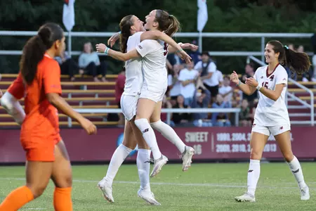 Claire Mensi and Sam Smith hug after a goal.