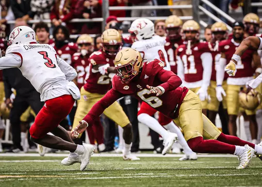 Donovan Ezeiruaku reaches to tackle Louisville QB Malik Cunningham.