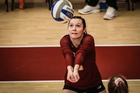 Anna Murphy goes up for a dig vs Virginia