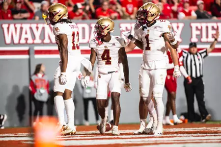 Zay Flowers is met in the end zone by Tomlin and Gill after his second touchdown at NC State.