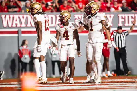 Zay Flowers is met in the end zone by Tomlin and Gill after his second touchdown at NC State.