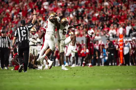 Donovan Ezeiruaku celebrates a tackle in the back field at NC State.