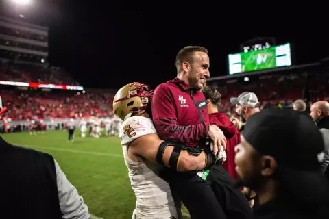 Marcus Vakdez lifts Jeff Hafley after the win at NC State.
