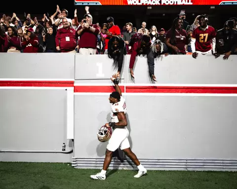 Donovan Ezeiruaku high-fives BC fans at NC State.