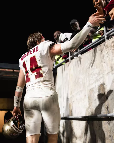 Emmett Morehead high-fives fans following the win at NC State.