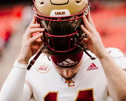 Emmett Morehead puts on his helmet at NC State.