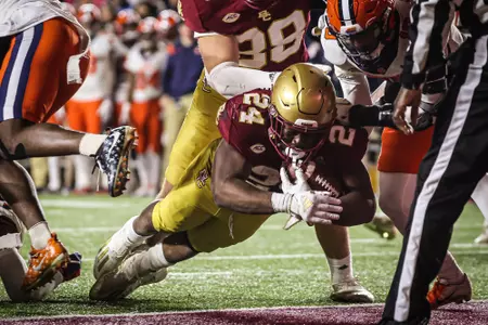 Pat Garwo crosses the goal line for a touch down, leaning out with the ball.