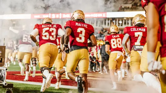 Jason Maitre and the Eagles run out of the tunnel prior to a 2022 games against Maine at Alumni Stadium.