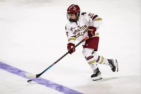 Olivia O'Brien carries the puck up the ice through the neutral zone.