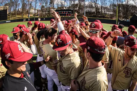 Baseball team huddle prior to 2022 game vs. UMass at the Harrington Athletics Village.