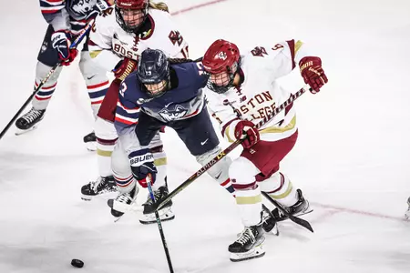 Kiley Erickson fights for the puck against UConn.