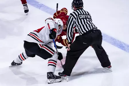 Cam Burke takes a faceoff at Northeastern