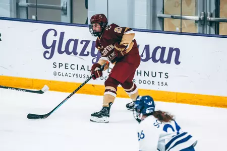 Abby Newhook carries the puck against Holy Cross.