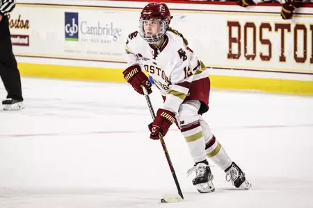 Cailin Flynn skates with the puck in the neutral zone.