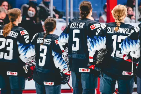Left to right, Alex Carpenter, Cayla Barnes and Megan Keller stand on the blue line with Team USA.