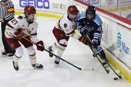 Willow Corson and Maddie Crowley-Cahill battle for the puck.
