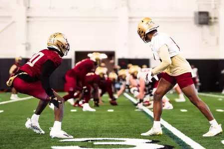 Elijah Jones (20) and Jaden Williams (0) in offense vs. defense.