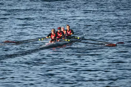 A BC. four-person boat competes on the Charles River.