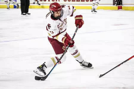 Abby Newhook shoots the puck against Maine.