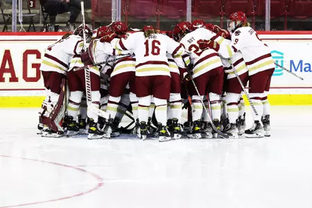 The Eagles huddle around the net before a game.