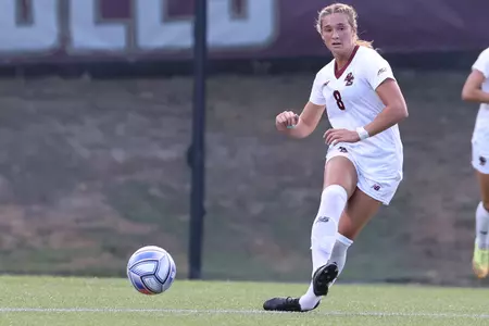 Laura Gouvin looks to pass the ball up the field during a home soccer game.