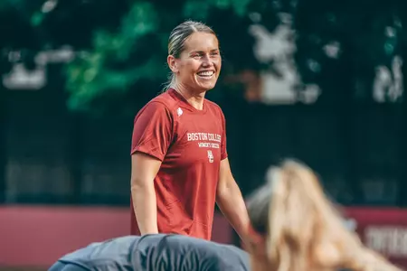 Paige Forster smiles as she directs a warmup during a practice.