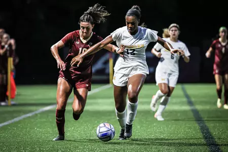 Emily Sapienza fights for the ball against a Michigan player.