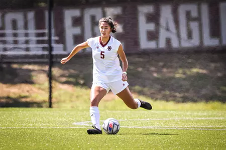 Sonia Walk kicks the ball up the field against Holy Cross.