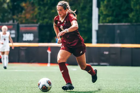 Laura GOuvin dribbles the ball up the field against Northeastern.