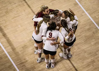 BC/Marist recap photo of BC volleyball team huddling up