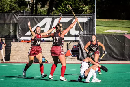 Peyton Hale and Juliette Hijdra celebrate a goal in a field hockey win over Virginia